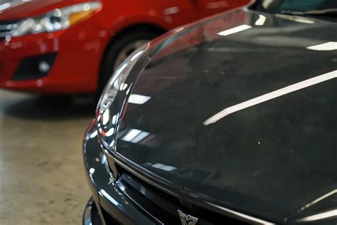 how to wax a black car and why does a black car reflect more sunlight?